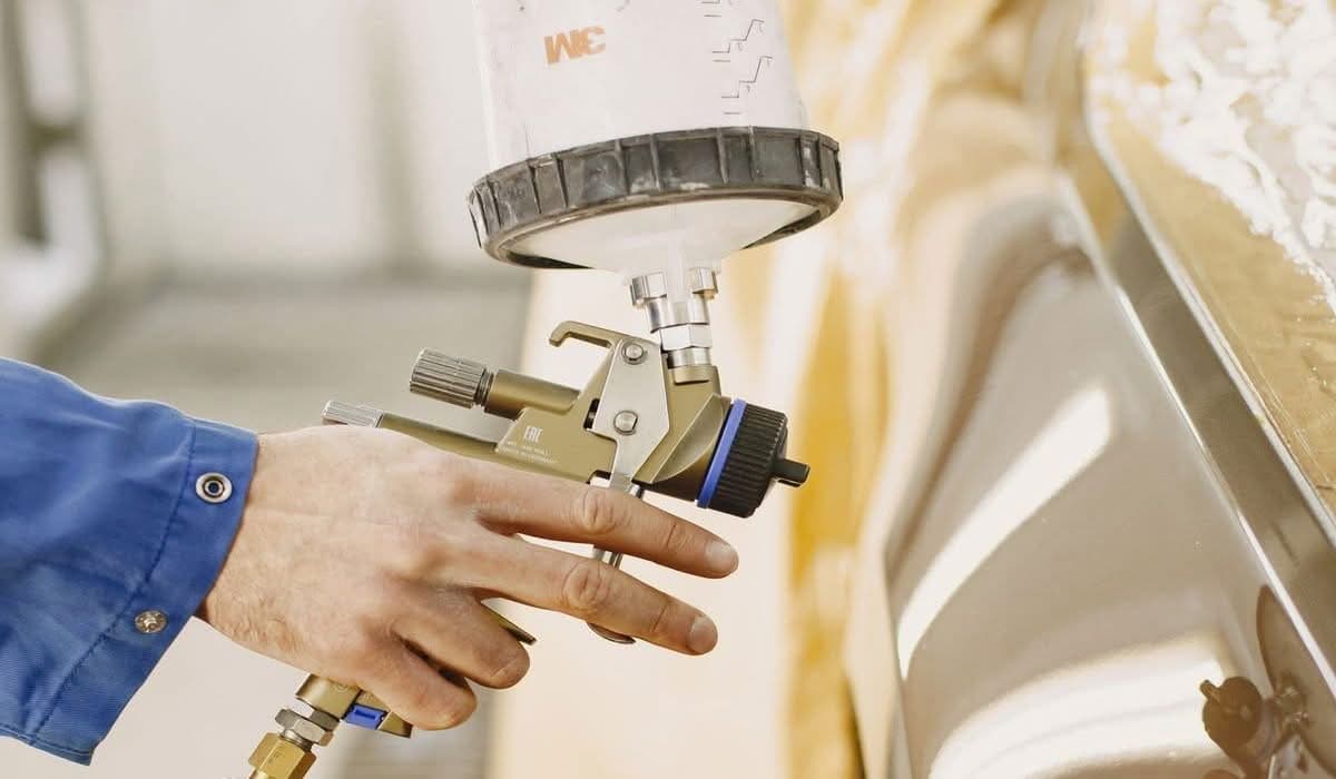 How Mobile Auto Paint Services Save Time and Money 9 Mobile technician applying automotive paint touch-up with a spray gun