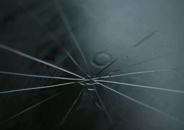 Close-up of a star-shaped rock chip crack in a windshield