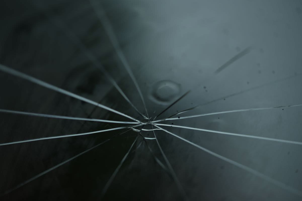 Close-up of a star-shaped rock chip crack in a windshield