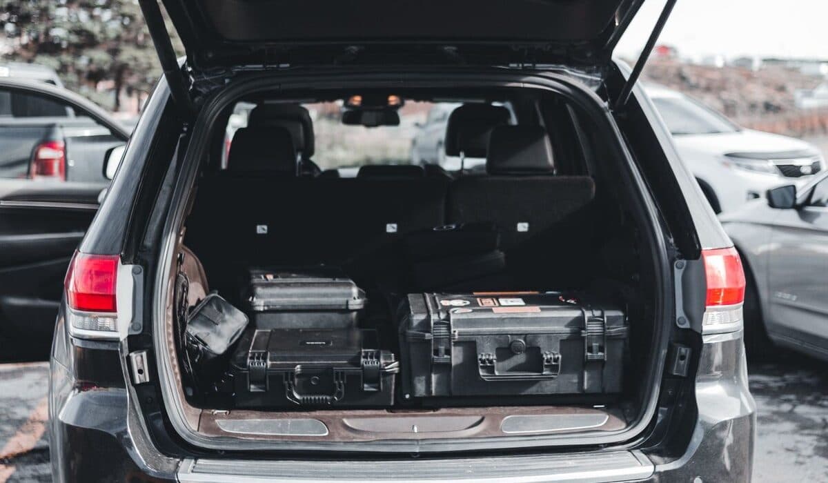 Mobile auto paint technicians vehicle loaded with professional equipment cases for on-site service