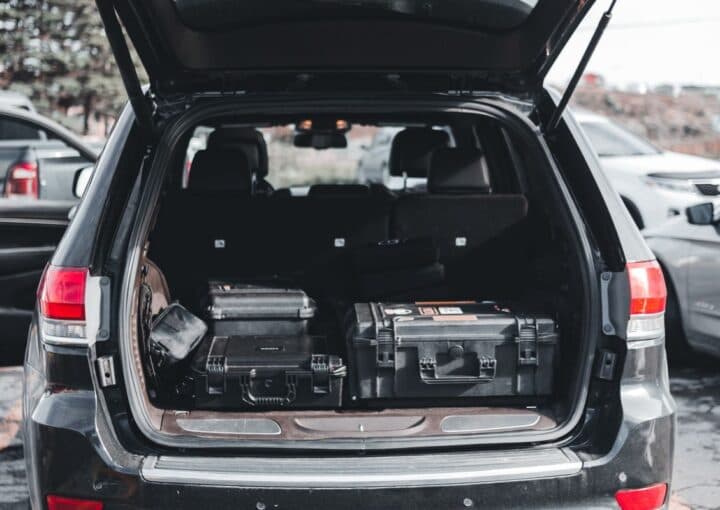 Mobile auto paint technicians vehicle loaded with professional equipment cases for on-site service