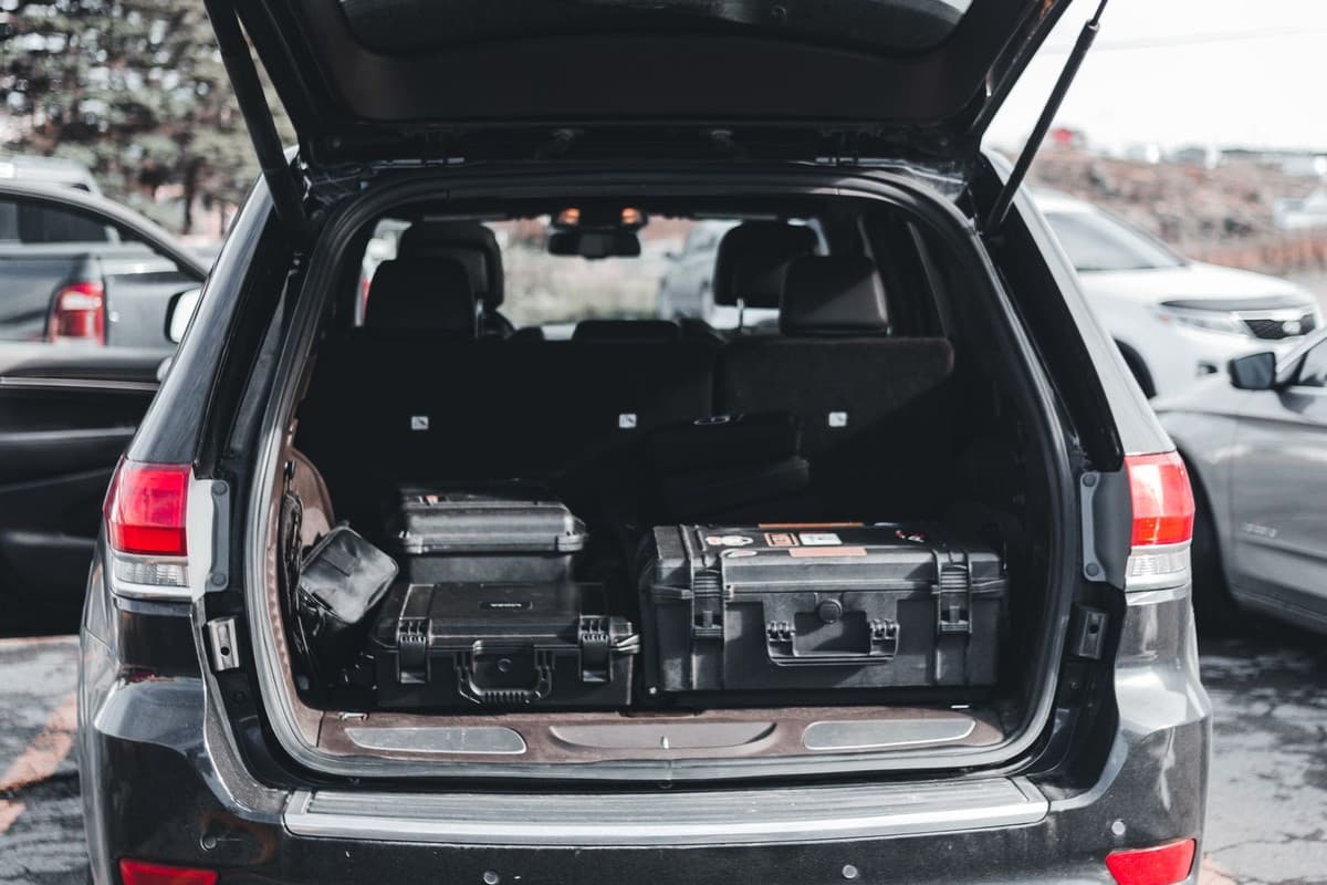 Mobile auto paint technicians vehicle loaded with professional equipment cases for on-site service