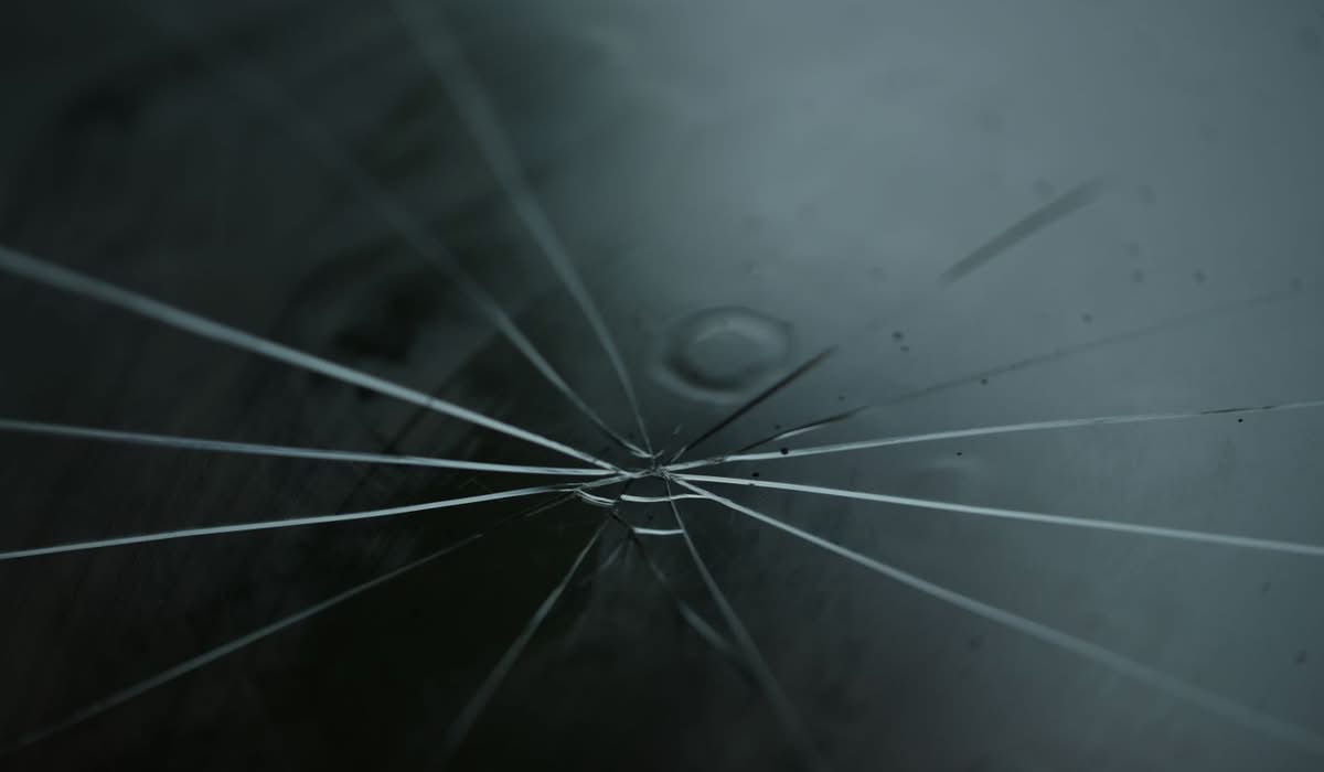 Close-up of a star-shaped rock chip crack in a windshield