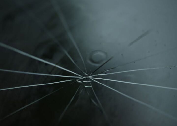Close-up of a star-shaped rock chip crack in a windshield