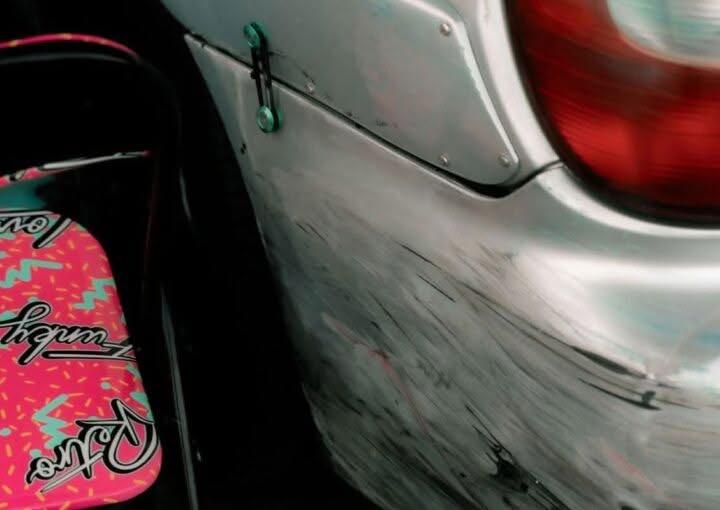 Scuffed and scratched car bumper showing cosmetic paint damage